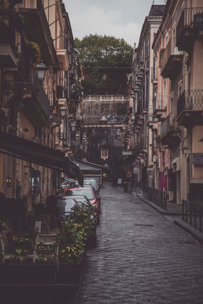 Explore the picturesque cobblestone streets of Taormina lined with historic buildings.