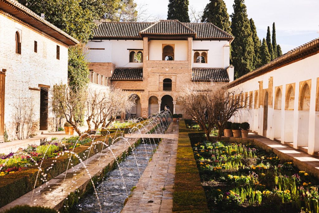 Captivating view of a garden courtyard at the Alhambra Palace in Granada, Spain.
